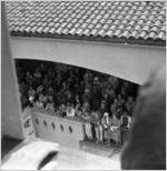 Crowd watching festivities from a covered balcony, Honolulu, Hawaii, 1930s