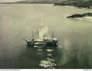 New Hanover Island, Britain Group, Pacific Ocean, 1943-02-16. Aerial view of RAAF aircraft strafing a small Japanese freighter. (Donor: Mrs B.E. Ball)