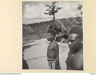 MAPRIK, NEW GUINEA. 1945-10-03. NATIVES ON PARADE AT AUSTRALIAN NEW GUINEA ADMINISTRATIVE UNIT HEADQUARTERS FOR AN INSPECTION BY CAPTAIN M. VERSO, MEDICAL OFFICER