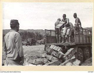 BLANCHE BAY, RABAUL, NEW BRITAIN. 1945-10-03. JAPANESE TROOPS UNLOADING 150MM SHELLS FROM TRUCKS AT THE BARGE POINT. THE SHELLS WILL BE TRANSPORTED TO SEA FOR DUMPING UNDER 28 INFANTRY BATTALION ..