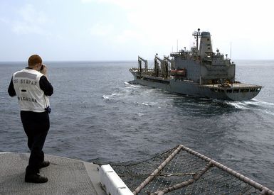 U.S. Navy Quartermaster Second Class Jason Lentz checks the distance between his ship, the Tarawa Class Amphibious Assault Ship USS SAIPAN (LHA 2), and the Military Sealift Command Henry J. Kaiser Class Oiler USNS LEROY GRUMMAN (T-AO 195) in preparation for an underway replenishment operation in the Gulf of Aden on Sept. 9, 2006. SAIPAN is currently underway conducting maritime security operations in the Persian Gulf. (U.S. Navy photo by Mass Communication SPECIALIST Third Class Gary L. Johnson III) (Released)