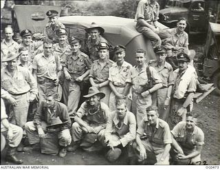 VIVIGANI, GOODENOUGH ISLAND, PAPUA. 1944-01-17. AN INFORMAL GROUP PORTRAIT OF CREWS OF NO. 100 (BEAUFORT) SQUADRON RAAF ON THEIR WAY TO BE INTERROGATED AFTER RETURNING FROM A MASSED DAYLIGHT RAID ..