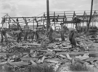 NAURU ISLAND. 1945-09-14. TROOPS OF THE 31/51ST INFANTRY BATTALION CLEARING AWAY SOME OF THE WRECKAGE AT THE BRITISH PHOSPHATE COMMISSION WORKSHOPS SOON AFTER THEIR OCCUPATION OF THE ISLAND