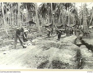 SIAR-NAGADA, NEW GUINEA. 1944-09-08. PERSONNEL OF B COMPANY, 61ST INFANTRY BATTALION "THE QUEENSLAND CAMERON HIGHLANDERS", REPAIRING A ROAD THROUGH THE CAMP AREA