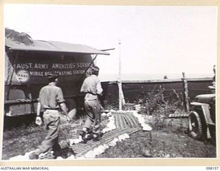 WEWAK POINT, NEW GUINEA. 1945-10-23. THE BROADCASTING STATION AREA AT RADIO STATION 9AJ, 1 BROADCASTING STATION, AUSTRALIAN ARMY AMENITIES SERVICE. THE MOBILE TRUCK CONTAINS THE ENTIRE EQUIPMENT