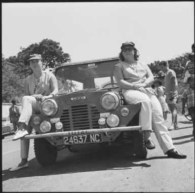 Two women sitting on a jeep during the 1st Safari Calédonien rally racing event, New Caledonia, 1967 / Michael Terry