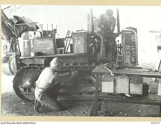 PORT MORESBY, NEW GUINEA. 1944-04-10. VX70574 CRAFTSMAN J.T. PONCHARD, LEFT  (1), WITH VX87094 CRAFTSMAN W.T. SHAW (2), AT THE 1ST MECHANICAL EQUIPMENT WORKSHOP, AUSTRALIAN ELECTRICAL AND ..