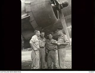 NEW GUINEA. C. 1944. RAAF AIRCREW STANDING IN FRONT OF A DOUGLAS TRANSPORT AIRCRAFT. LEFT TO RIGHT: FLIGHT SERGEANT (FL SGT) DAVIES; FL SGT HARTLEY; FL SGT G. K. HALL; FLIGHT LIEUTENANT MCGINNIS