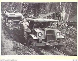 SOUTH BOUGAINVILLE. 1945-07-29. THREE TONNERS CARRYING URGENTLY REQUIRED ENGINEERS STORES FOR 15 FIELD COMPANY, ROYAL AUSTRALIAN ENGINEERS, BEING TOWED BY BULLDOZER THROUGH MUD AND SLUSH ON THE ..