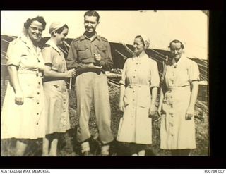 New Guinea. c. 1944. Three sisters, members of the Australian Army Nursing Service (AANS), a male doctor and a member of the Australian Army Medical Women's Service (AAMWS) (left) outside a tented ..