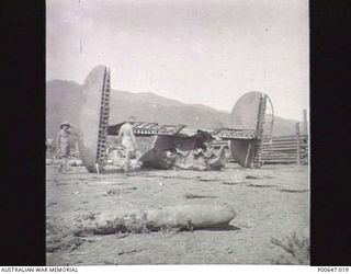 MILNE BAY, PAPUA, C.1943-01-19. REMAINS OF B-24 LIBERATOR AIRCRAFT ON NO 3 STRIP (TURNBULL FIELD) AFTER JAPANESE AIR RAID. (DONOR - T.G. JONES)