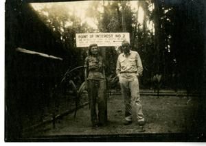 [Ivalee Holtz And Commander Edward Mason Standing In Front Of Sign]