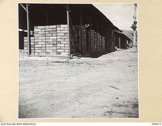 BORAM, NEW GUINEA, 1945-08-06. THE ADVANCED SUPPLY DEPOT WHERE AUSTRALIAN ARMY SERVICE CORPS SUPPLIES ARE STORED IN BULK AFTER BEING UNLOADED BY HQ COMMAND, AUSTRALIAN ARMY SERVICE CORPS, 6 ..