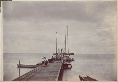 Men loading cargo onto boats. From the album: Cook Islands