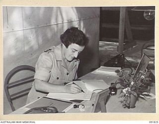 LAE, NEW GUINEA. 1945-05-15. LIEUTENANT COLONEL M.J. SPENCER, ASSISTANT CONTROLLER AUSTRALIAN WOMEN'S ARMY SERVICE, AT HER OFFICE DESK AT AUSTRALIAN WOMEN'S ARMY SERVICE HEADQUARTERS