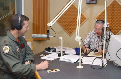 US Air Force (USAF) Major (MAJ) Donald Nesbitt (left), 325th Bomb Squadron B-2 Bomber Pilot, from Whiteman Air Force Base (AFB), Missouri (MO), is interviewed by Mr. Jon Anderson (right), a radio host with News Talk Radio K57, Guam, while he is TDY to Andersen AFB, Guam (GU), participating in Exercise CORONET BUGLE 49, which is part of Air Combat Commands (ACC) ongoing Global Power mission