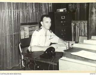 LANGEMAK BAY, NEW GUINEA. 1944-08-21. LIEUTENANT J.M. DUNN, RAN, SIGNALS OFFICER AND THE CAPTAIN'S SECRETARY AT THE RAN STAFF OFFICE