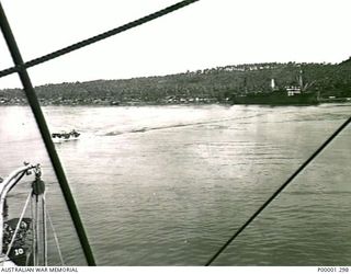 NEW BRITAIN, 1945-09. VIEW OF PART OF SIMPSON HARBOUR, RABAUL, ON THE ARRIVAL OF THE AUSTRALIAN MISSING PRISONERS INVESTIGATION UNIT (MPIU). (RNZAF OFFICIAL PHOTOGRAPH.)
