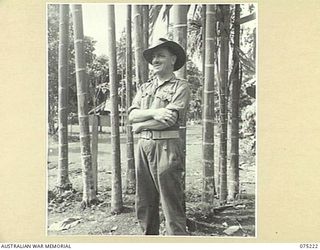 LAE, NEW GUINEA. 1944-08-06. N103846 LIEUTENANT A.P.K. MORRIS, SECOND IN CHARGE, NEW GUINEA FORCE AMENITIES SECTION, SMILES HAPPILY FOR HIS PHOTOGRAPH