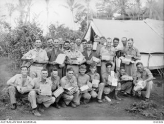 PORT MORESBY, PAPUA. C. 1942-12. AUSTRALIAN COMFORTS FUND CHRISTMAS HAMPERS MEANT A LOT TO THE RAAF IN THE JUNGLE JUDGING BY THESE SMILES