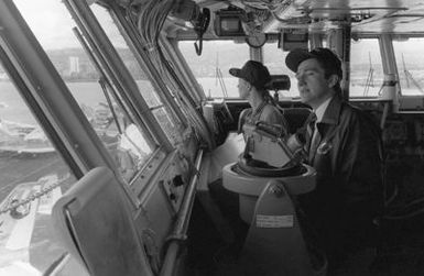 Secretary of the Navy John F. Lehman Jr. and his wife visit the bridge of the aircraft carrier USS KITTY HAWK (CV-63)