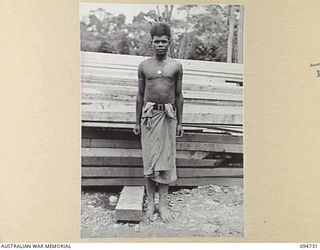 YALU AREA, NEW GUINEA, 1945-07-30. THE NATIVES' BOSS BOY, NO. 2 PLATOON, 2/1 FORESTRY COMPANY, ROYAL AUSTRALIAN ENGINEERS