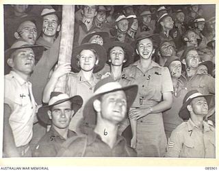 HERBERTON, QLD. 1945-01-20. SERVICEMEN FROM 25 LINES OF COMMUNICATION AREA SIGNALS, WATCH THE FINISH OF THE SECOND DIVISION, (4 FURLONGS) RACE, DURING THE 9 DIVISION GYMKHANA AND RACE MEETING HELD ..