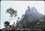 Soccer (football) match: spectators on a rock formation