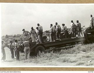 1944-01-26. AUSTRALIAN AND NEW GUINEA ADMINISTRATION UNIT NATIVES INSPECTING A COMPLETED TANK CARRIER WHICH HAS A CARRYING CAPACITY OF 40 TONS AT THE FACTORY OF THE FORD MOTOR COMPANY