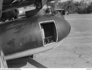 PIVA AIRSTRIP TOROKINA, BOUGAINVILLE, 1945-07-12. SIDE VIEW SHOWING HOW LIEUTENANT KINNA FITTED HIS MOVIE CAMERA INTO THE BELLY TANK OF THE ROYAL NEW ZEALAND AIR FORCE CORSAIR IN ORDER TO OBTAIN ..