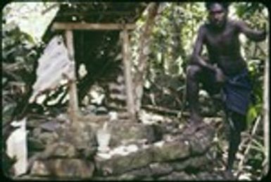 Man leaning on shrine