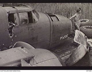 NEW GUINEA. 1943-09-29. CRASHED MITCHELL BOMBER "PI JOE" WHICH CRASHED DURING A "TAKE-OFF" LOADED ONTO A SEMI-TRAILER OF THE UNITED STATES AIR FORCE. IN THIS CRASH BRIGADIER R. B. SUTHERLAND WAS ..