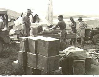 1943-06-29. NEW GUINEA. WAU-MUBO AREA. TRANSPORT PLANES UNLOADING AT AN ADVANCED LANDING GROUND. (NEGATIVE BY G. SHORT)