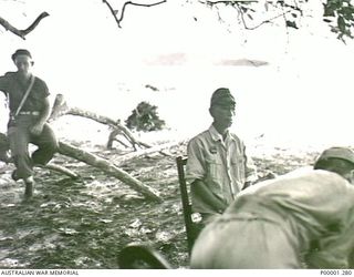 THE SOLOMON ISLANDS, 1945-10-13. JAPANESE OFFICER AWAITING INTERROGATION AT KANDAS ISLAND INTERNMENT CAMP. (RNZAF OFFICIAL PHOTOGRAPH.)