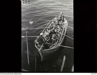 MILNE BAY, PAPUA. C. 1944-02. AIRMEN OF NO. 75 SQUADRON RAAF IN THE SHIP'S LIFEBOAT AT BOAT DRILL WHILST AT MILNE BAY EN ROUTE TO LAE