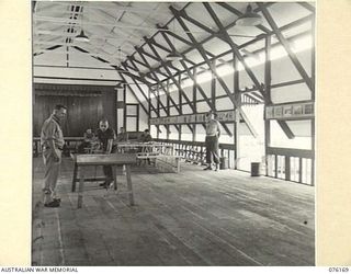 LAE, NEW GUINEA. 1944-09-02. THE INTERIOR OF THE RECREATION HALL BUILT BY MEMBERS OF THE 22ND WORKS COMPANY, ROYAL AUSTRALIAN ENGINEERS. THE HALL HAS A FULL SIZE STAGE MEASURING 30 FEET BY 18 FEET ..