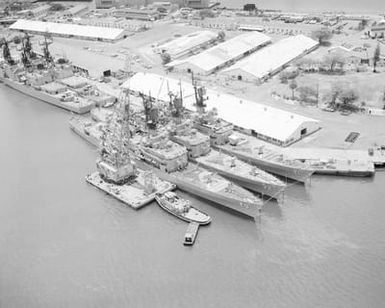 An aerial view of the guided missile cruisers USS JOUETT (CG 29), USS WILLIAM H. STANDLEY (CG 32) and USS GRIDLEY (CG 21) moored to berth K-3 during Exercise RIMPAC '86