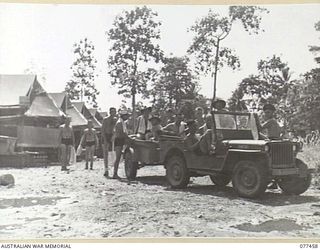 LAE BASE AREA, NEW GUINEA. 1944-12-04. PERSONNEL OF THE 2/77TH LIGHT AID DETACHMENT BOARDING THE UNIT JEEP AND TRAILER FOR THE TRIP TO MALAHANG BEACH FOR THEIR DAILY SWIM
