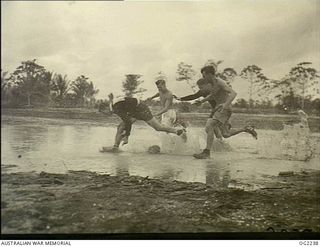 MOROTAI, HALMAHERA ISLANDS, NETHERLANDS EAST INDIES. C. 1945-01-25. NOT THE MELBOURNE CRICKET GROUND IN WINTER TIME BUT THE MOROTAI SPORTS OVAL IN THE HALMAHERAS DURING AN AUSTRALIAN RULES FOOTBALL ..