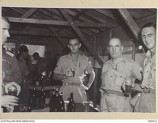 TOROKINA, BOUGAINVILLE. 1945-04-09. WO I, C. MURRAY, PRESIDENT OF THE SGTS MESS, HQ 2 CORPS (3), WITH SENATOR J.M. FRASER, ACTING MINISTER FOR THE ARMY (2), AND WO I, G. MATHESON, VICE-PRESIDENT OF ..