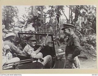 BOUGAINVILLE, 1945-05-12. LT-GEN V.A.H. STURDEE, GOC FIRST ARMY (1), BEING GREETED BY BRIG H.H. HAMMER, COMD 15 INFANTRY BRIGADE (2), ON ARRIVAL AT HQ 15 INFANTRY BRIGADE WHEN VISITING BRIGADE ..