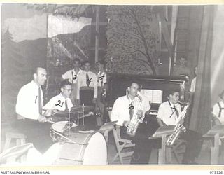 LAE, NEW GUINEA. 1944-08-17. THE ORCHESTRA OF THE WHITE HORSE IN CONCERT PARTY ON STAGE DURING THE PLAYING OF "THE WHITE HORSE INN" AT HEADQUARTERS, NEW GUINEA FORCE. THE CONCERT PARTY CONSISTS OF ..