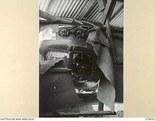 Tadji, New Guinea. 1945-01-20. The nose of A9-557, a DAP Beaufort bomber, operated by No 100 Squadron RAAF, sticking through the wall of the RAAF Air Transport Command office. This aircraft ..