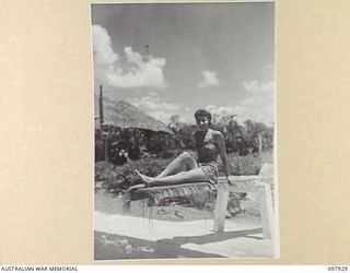 LAE, NEW GUINEA. 1945-10-20. SERGEANT P. D'OLIVERRA, AUSTRALIAN WOMEN'S ARMY SERVICE, FIRST ARMY, SUNBAKING ON THE SPRINGBOARD AFTER A DIP IN THE AUSTRALIAN NEW GUINEA ADMINISTRATIVE UNIT SWIMMING ..