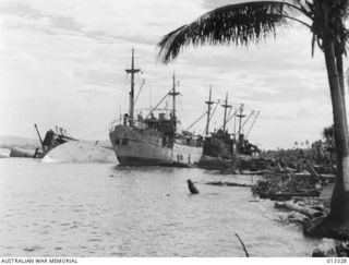 1942-10-01. NEW GUINEA. MILNE BAY: AN ALLIED VESSEL SUNK BY JAPANESE WARSHIPS DURING THE UNSUCCESSFUL JAPANESE ATTACK ON MILNE BAY. SHIPS NEARBY WERE UNDAMAGED