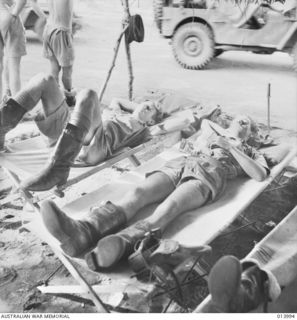 PAPUA. 1942-12-05. AT AN ADVANCED POST, WIRRAWAY PILOT OFFICER NEIL HUTCHINSON, OF MILDURA, VIC, AND OBSERVER PILOT OFFICER NORMAN A. JOBSON, OF NO. 4 TACTICAL RECONNAISSANCE SQUADRON RAAF, RELAX ..