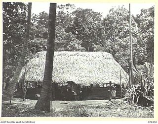 TAGUM VILLAGE, NEW BRITAIN. 1945-01-14. THE HEADQUARTERS OF THE AUSTRALIAN AND NEW GUINEA ADMINISTRATIVE UNIT - NEW BRITAIN DISTRICT IN THE VILLAGE, NORTH OF SAMPUN ON THE WIDE BAY COAST