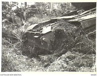 MADANG, NEW GUINEA. 1944-10-12. A CHURCHILL V TANK BOGGED AT A CREEK CROSSING DURING TESTS CONDUCTED AT HQ 4 ARMOURED BRIGADE