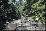 Man standing by creek