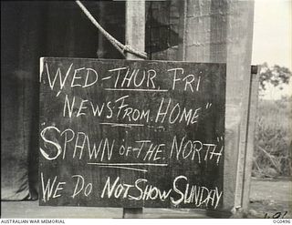 NEW GUINEA. 1944-01-08. THE "BILL OF FARE" SIGN OUTSIDE THE ENTRANCE TO A RAAF JUNGLE PICTURE THEATRE IN THE AREA